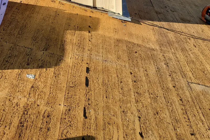 Bare plywood roof deck after the old roof was torn off