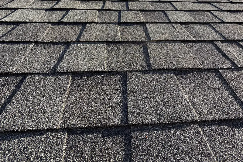Close view of new dimensional shingles in rows up a roof slope