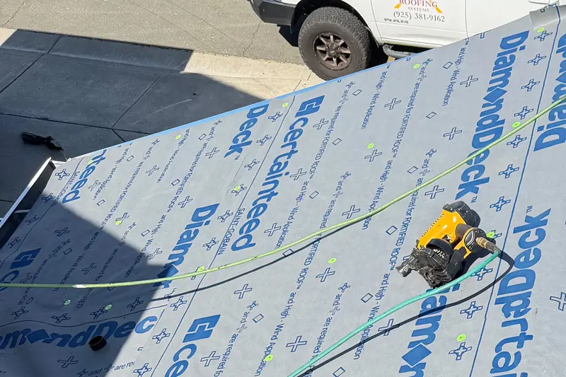 CertainTeed DiamondDeck synthetic underlayment rolled out over a roof deck