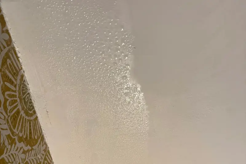Water droplets beading on a ceiling corner
