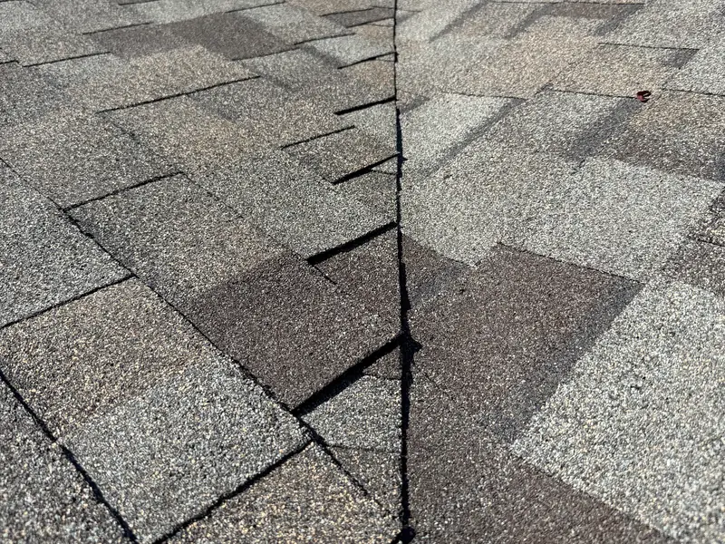 Architectural shingles meeting in a valley on a finished roof