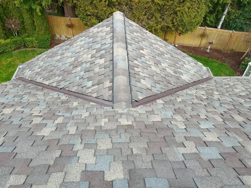 A hip roof covered in multicolor shake-style shingles